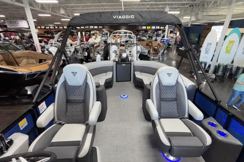 Slide: The Image of 2026 Viaggio Z24U pontoon boat interior with luxurious seating and modern design in showroom. - 24