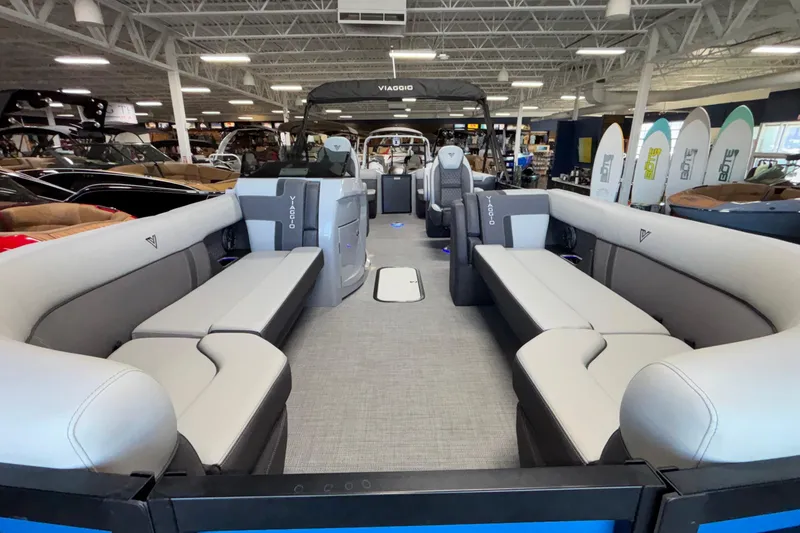 Slide: The Image of 2026 Viaggio Z24U pontoon boat interior with spacious seating in showroom. - 5
