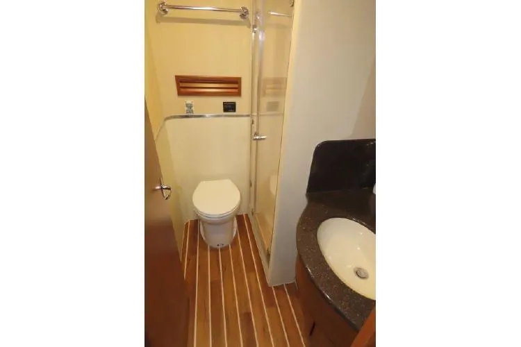 Slide: The Image of 2011 Henriques 42 Flybridge bathroom with shower, toilet, and sink. - 13