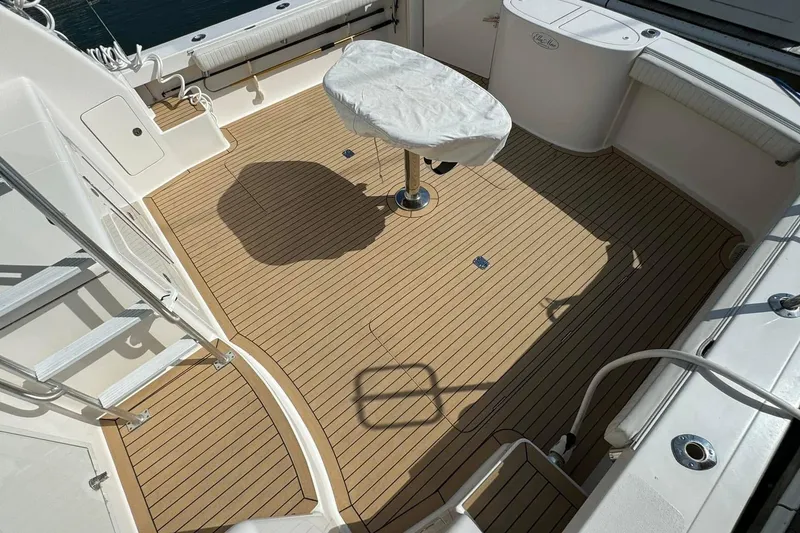 Slide: The Image of Henriques 42 Flybridge 2011 boat deck with covered table and seating area. - 14
