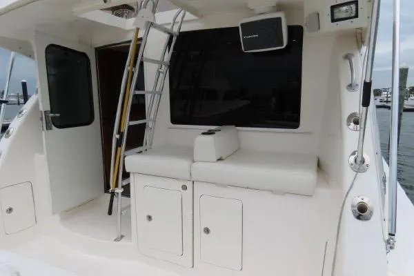 Slide: The Image of Henriques 42 Flybridge 2011 boat deck with seating, ladder, and storage compartments. - 24