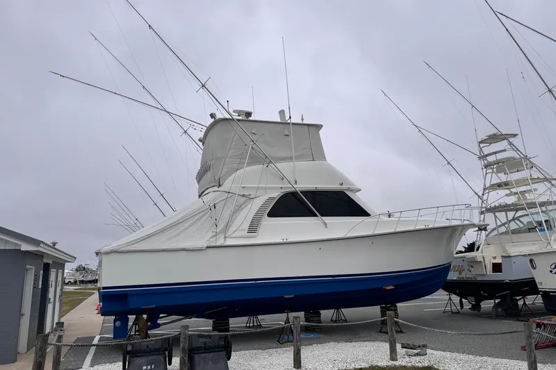 Slide: The Image of 2011 Henriques 42 Flybridge boat on dry dock, covered and ready for maintenance. - 28