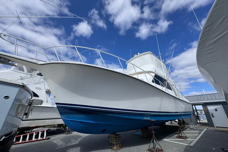 Slide: The Image of 2011 Henriques 42 Flybridge boat on stands under a blue sky. - 29