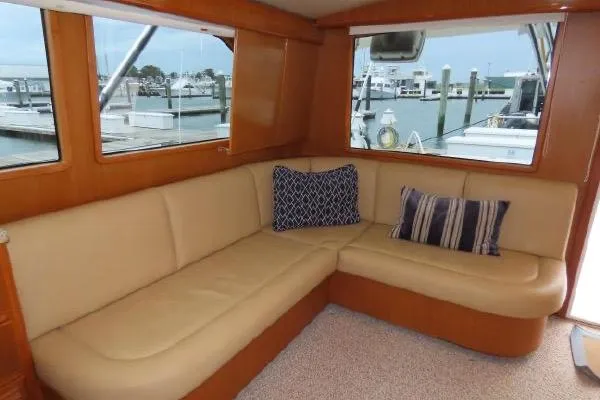 Slide: The Image of Interior of 2011 Henriques 42 Flybridge with beige leather seating and decorative pillows. - 4
