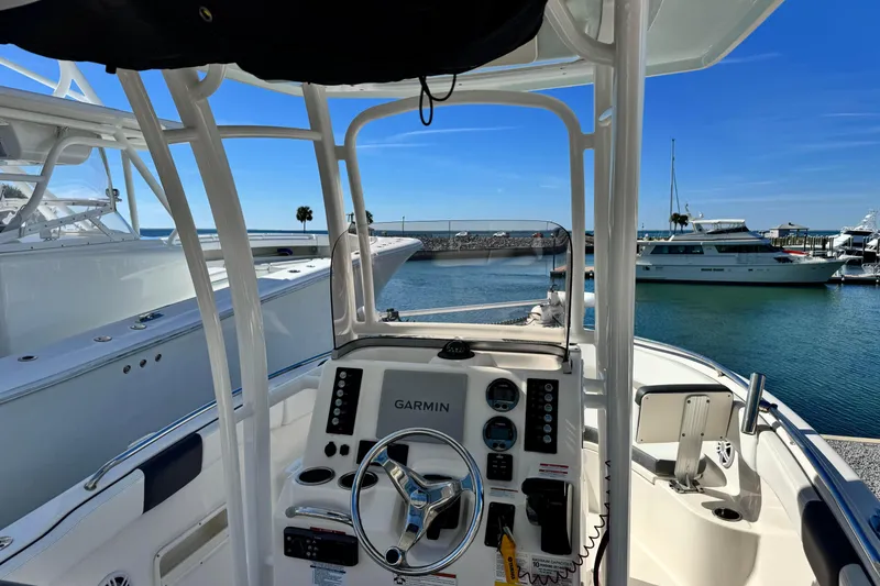 Slide: The Image of 2020 Robalo R222 Center Console boat at marina, featuring Garmin navigation system. - 11