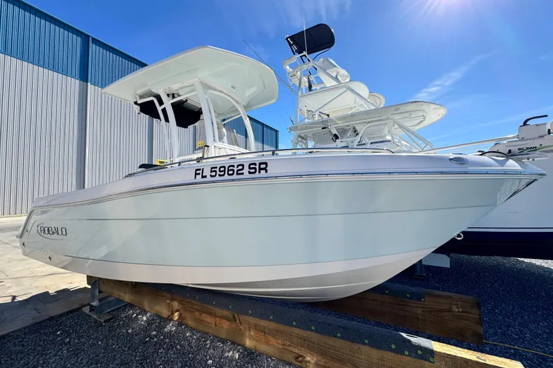 Slide: The Image of 2020 Robalo R222 Center Console boat on display under clear blue sky. - 2