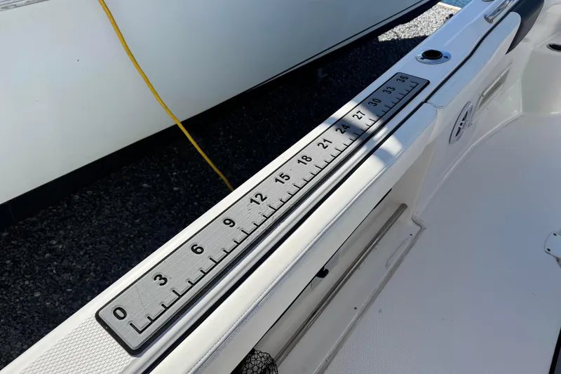 Slide: The Image of 2020 Robalo R222 Center Console boat with built-in measuring ruler on deck. - 20