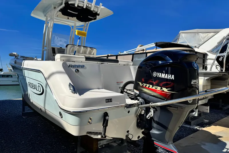 Slide: The Image of 2020 Robalo R222 Center Console boat with Yamaha VMAX 250 engine, docked outdoors. - 6