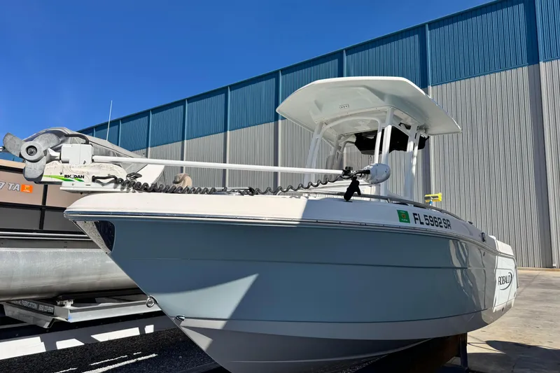 Slide: The Image of 2020 Robalo R222 Center Console boat docked outdoors under clear blue sky. - 7