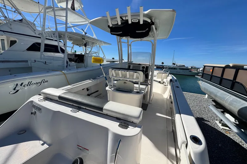Slide: The Image of 2020 Robalo R222 Center Console boat docked at marina under clear blue sky. - 8