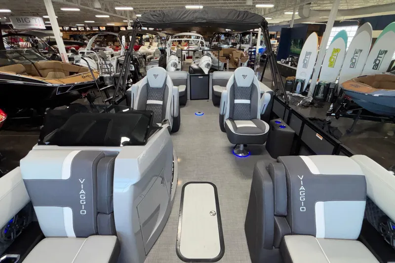Slide: The Image of 2026 Viaggio Z24U pontoon boat interior with luxurious seating and modern design in showroom. - 13