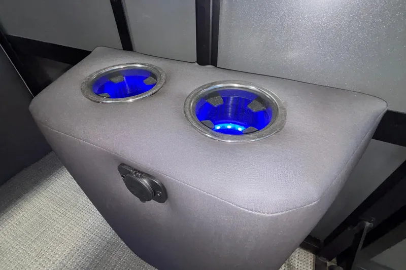 Slide: The Image of Cup holders with blue LED lights in a 2026 Viaggio Z24U vehicle interior. - 38