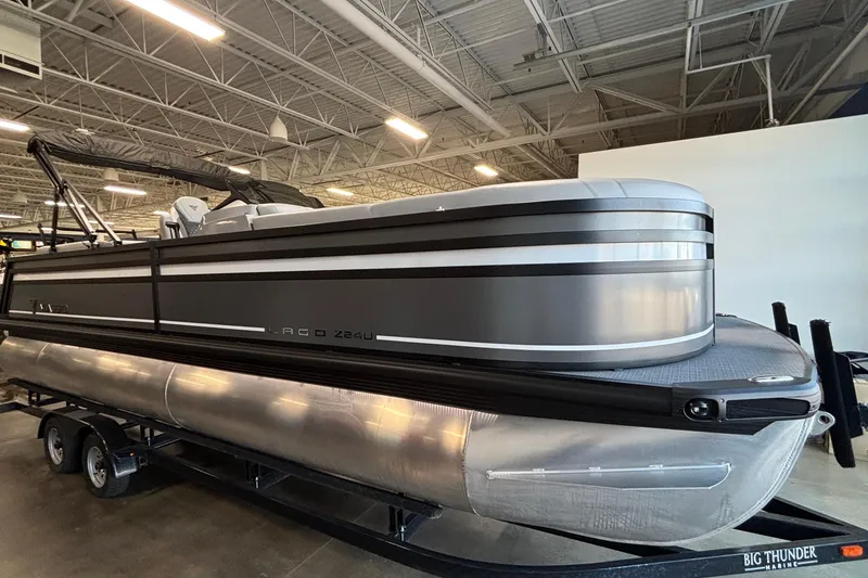 Slide: The Image of 2026 Viaggio Z24U pontoon boat in showroom, sleek design, on trailer. - 5