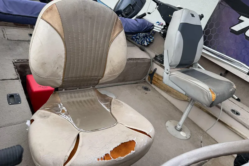 Slide: The Image of Worn seats in a 2000 Crestliner 1650 Fish Hawk boat interior. - 9