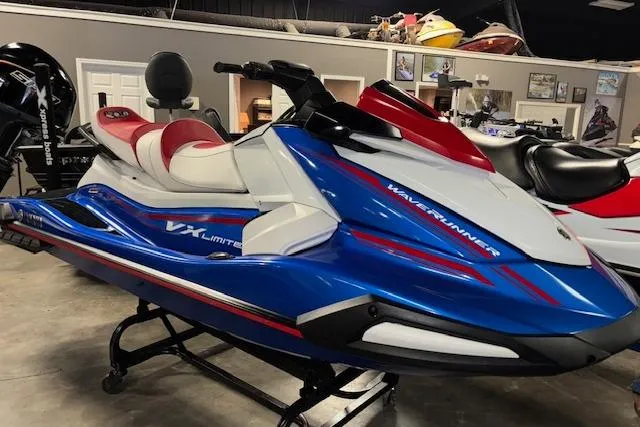 The Image of 2023 Yamaha WaveRunner VX Limited in showroom, blue and red design, side view. - 1