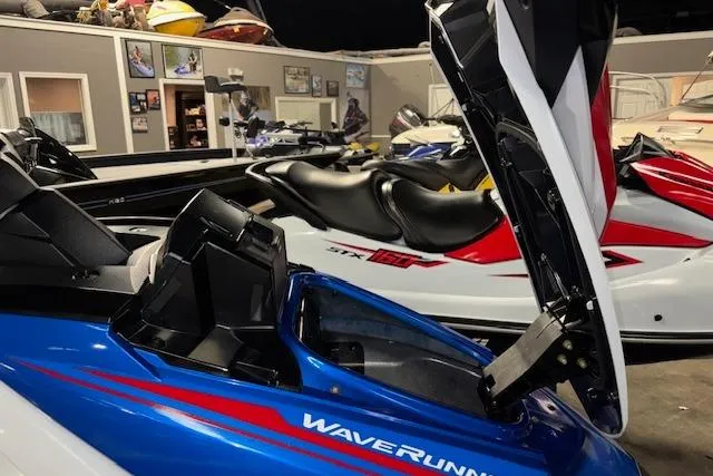 Slide: The Image of 2023 Yamaha WaveRunner VX Limited in showroom, blue and white design, open storage compartment. - 15