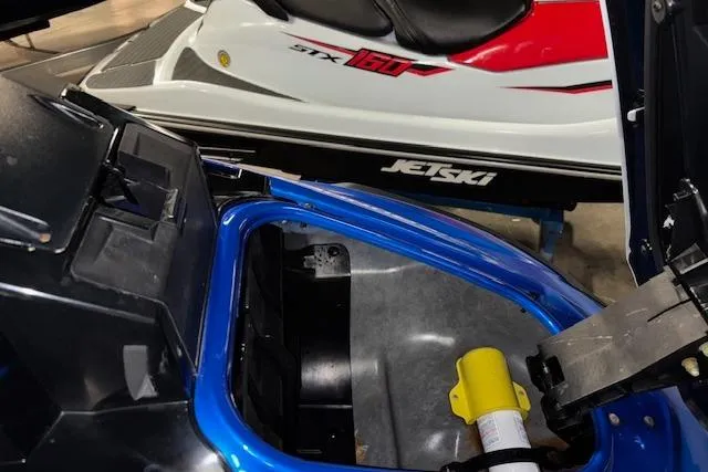 Slide: The Image of 2023 Yamaha WaveRunner VX Limited storage compartment with nearby jet ski. - 16