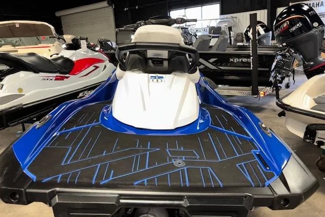 Slide: The Image of 2023 Yamaha WaveRunner VX Limited in showroom, blue and white design, rear view. - 8