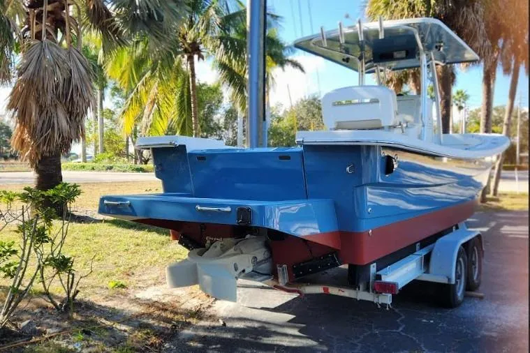 Slide: The Image of 2013 Panga Center Console boat on trailer, surrounded by palm trees. - 10