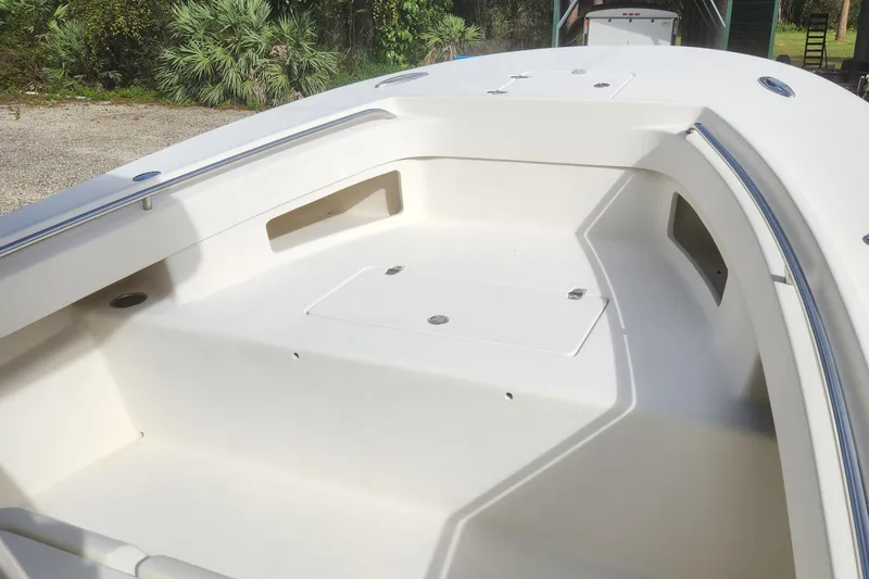 Slide: The Image of 2013 Panga Center Console boat interior with storage compartments and clean white finish. - 16