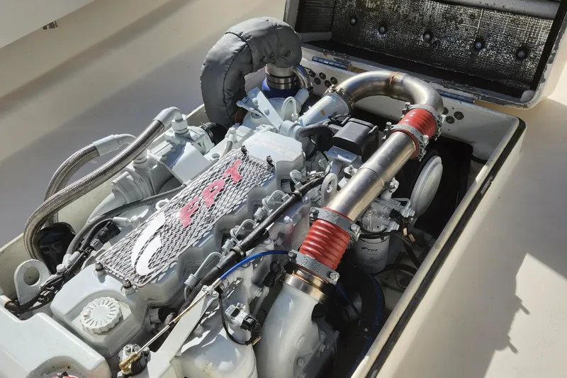 Slide: The Image of 2013 Panga Center Console boat engine with visible components and piping. - 27