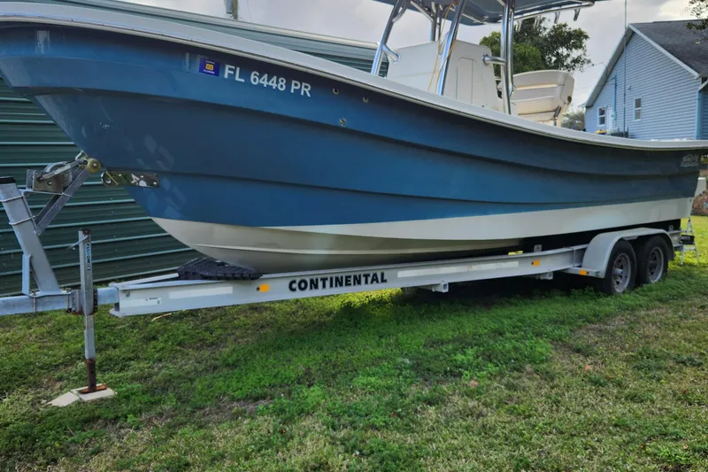Slide: The Image of 2013 Panga Center Console boat on Continental trailer, side view. - 8