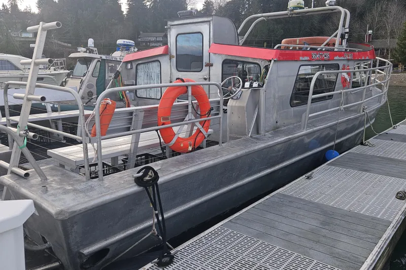 Slide: The Image of Aluminum boat docked, Svendsen Marine Works SMW 38, 1994 model, with safety equipment. - 2