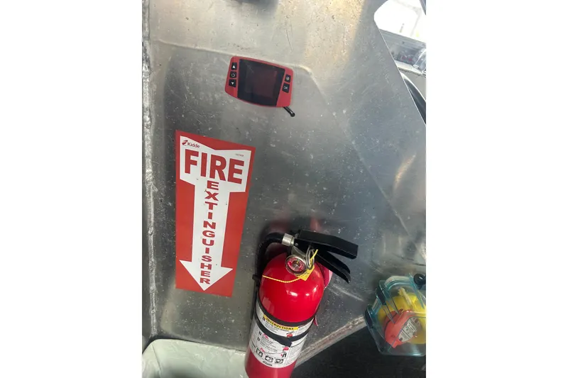 Slide: The Image of Fire extinguisher on Svendsen Marine Works SMW 38, 1994 model, with safety signage. - 20