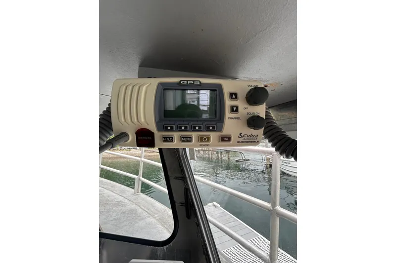 Slide: The Image of Cobra marine radio on Svendsen Marine Works SMW 38, 1994 model, docked by water. - 31