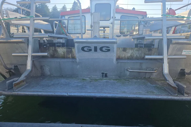 Slide: The Image of Custom SMW 38 boat from 1994, docked with visible stern and railing. - 32