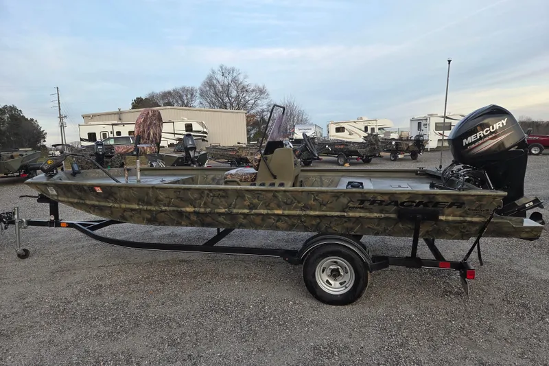 The Image of 2018 Tracker Grizzly 1860 CC boat with camo design and Mercury engine on trailer. - 0