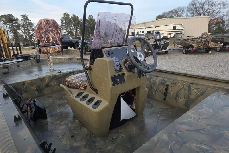 Slide: The Image of 2018 Tracker Grizzly 1860 CC boat interior with camouflage design and steering console. - 10