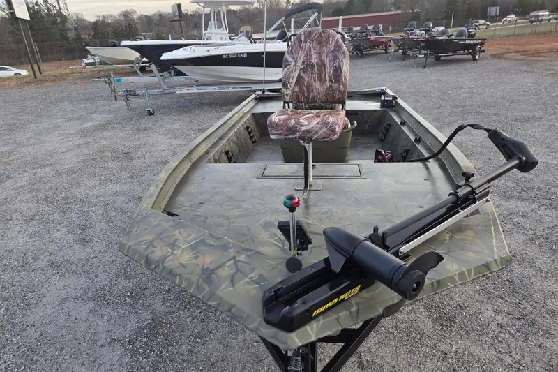 Slide: The Image of 2018 Tracker Grizzly 1860 CC boat with camouflage design and trolling motor. - 2