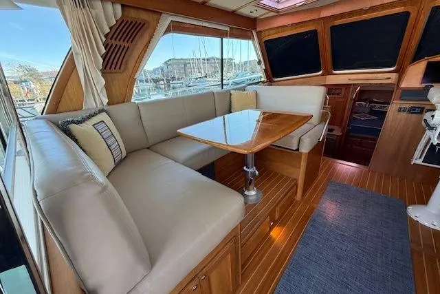 Slide: The Image of 2013 Sabre 38 Salon Express interior with elegant seating and wooden finishes. - 10