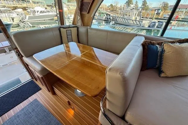 Slide: The Image of Interior of 2013 Sabre 38 Salon Express with elegant wooden table and plush seating. - 13