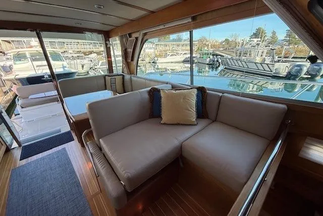Slide: The Image of Interior of 2013 Sabre 38 Salon Express yacht with plush seating and marina view. - 15