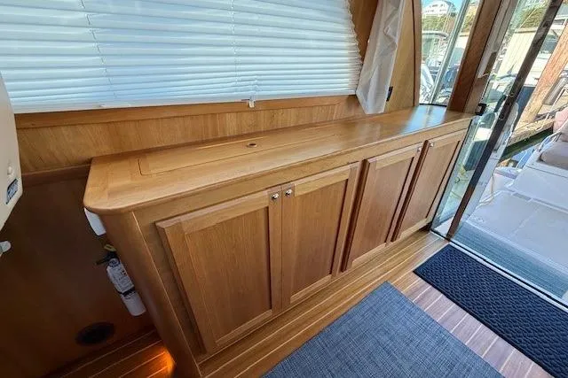 Slide: The Image of 2013 Sabre 38 Salon Express interior with wooden cabinetry and glass door. - 16