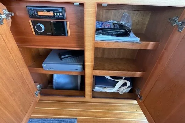 Slide: The Image of 2013 Sabre 38 Salon Express interior cabinets with audio equipment and storage shelves. - 17