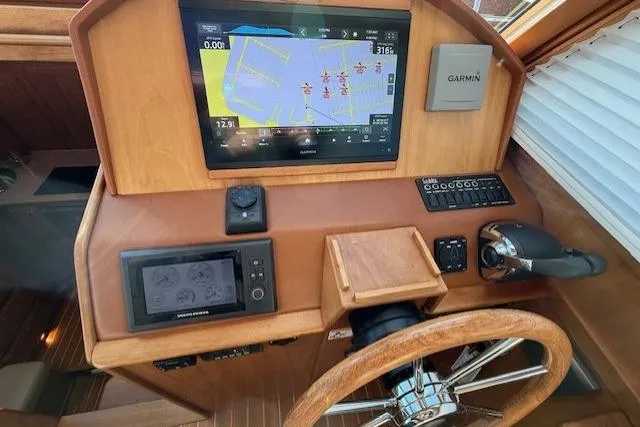Slide: The Image of 2013 Sabre 38 Salon Express helm with Garmin navigation system and wooden steering wheel. - 21