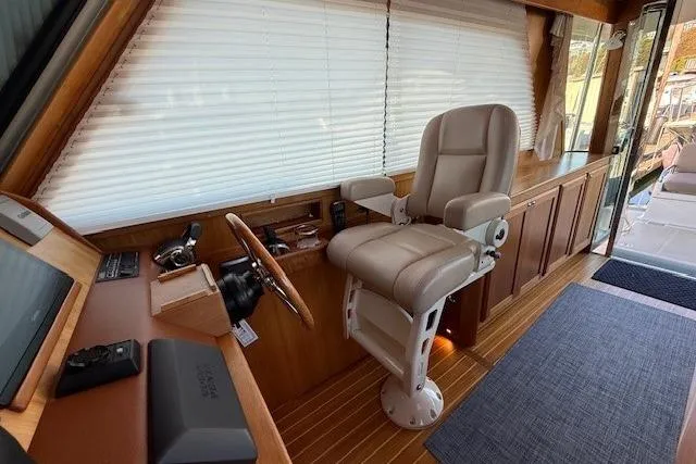 Slide: The Image of Interior of 2013 Sabre 38 Salon Express yacht with captain's chair and wooden accents. - 22
