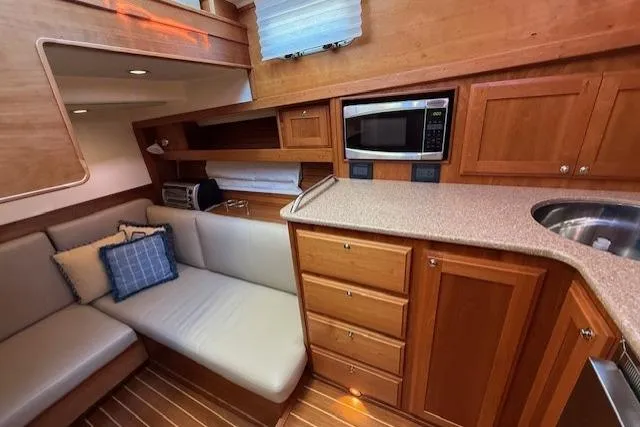 Slide: The Image of Luxurious interior of 2013 Sabre 38 Salon Express yacht with modern kitchen and cozy seating area. - 24
