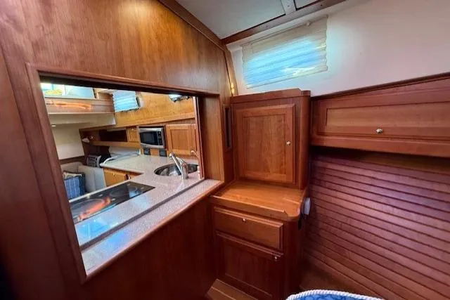 Slide: The Image of 2013 Sabre 38 Salon Express interior with wood cabinetry and modern kitchen amenities. - 28