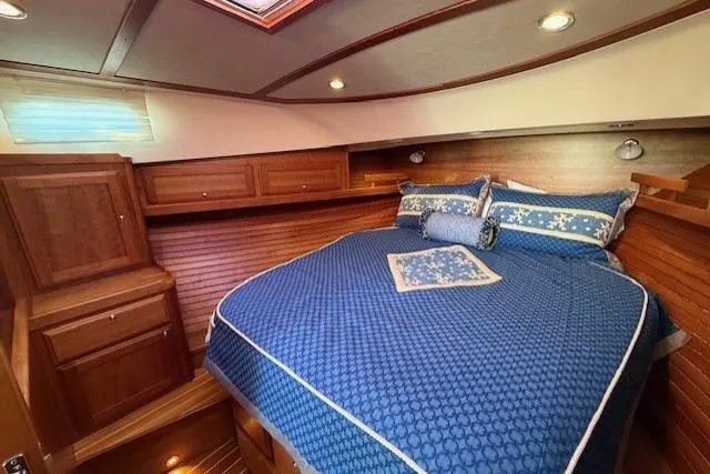 Slide: The Image of Luxurious cabin interior of 2013 Sabre 38 Salon Express with blue bedding and wood finish. - 29