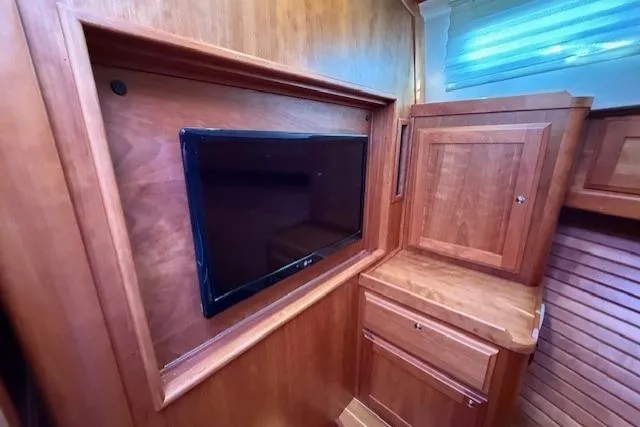 Slide: The Image of 2013 Sabre 38 Salon Express interior with wooden cabinetry and mounted TV. - 31