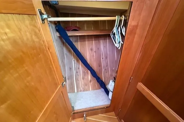 Slide: The Image of Wooden closet interior on 2013 Sabre 38 Salon Express yacht with hangers and shelf. - 32