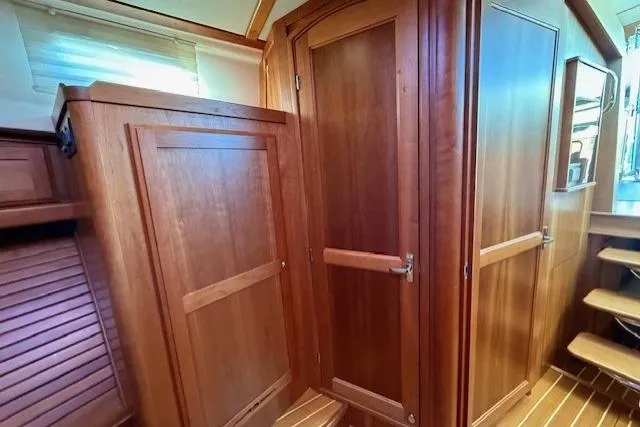 Slide: The Image of Interior of 2013 Sabre 38 Salon Express, featuring elegant wooden cabinetry and steps. - 33