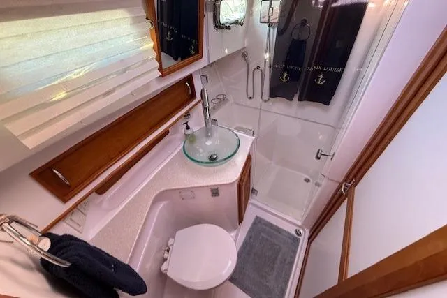 Slide: The Image of 2013 Sabre 38 Salon Express bathroom with glass sink, shower, and wooden accents. - 35