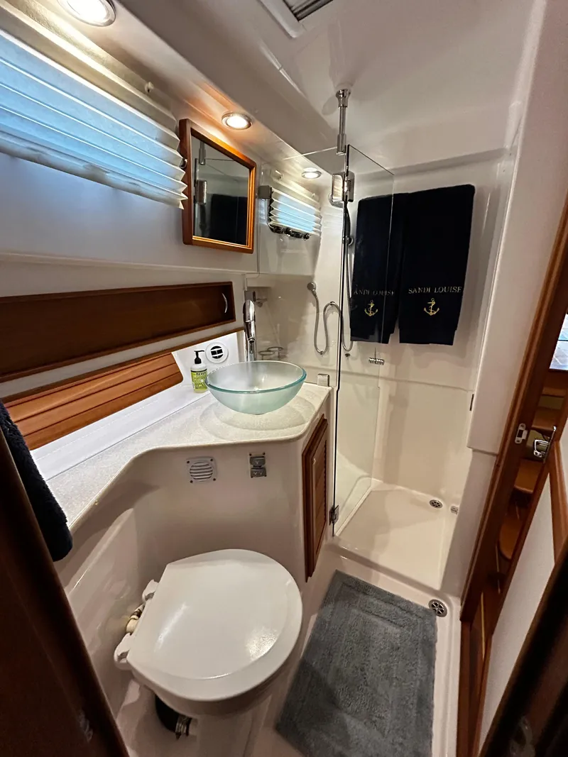 Slide: The Image of Luxurious bathroom in 2013 Sabre 38 Salon Express yacht with modern fixtures and glass sink. - 36