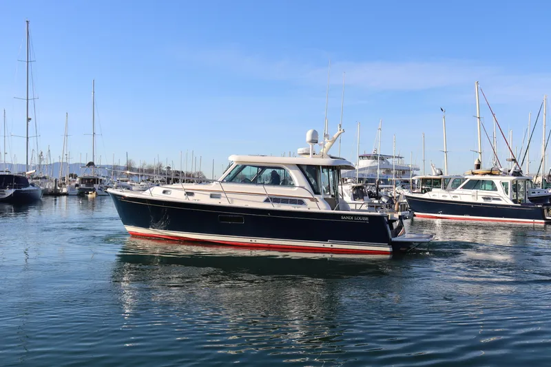 Slide: The Image of 2013 Sabre 38 Salon Express yacht docked in a marina, surrounded by other boats. - 4