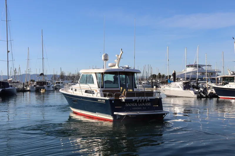 Slide: The Image of 2013 Sabre 38 Salon Express yacht in marina, clear sky, calm water. - 5